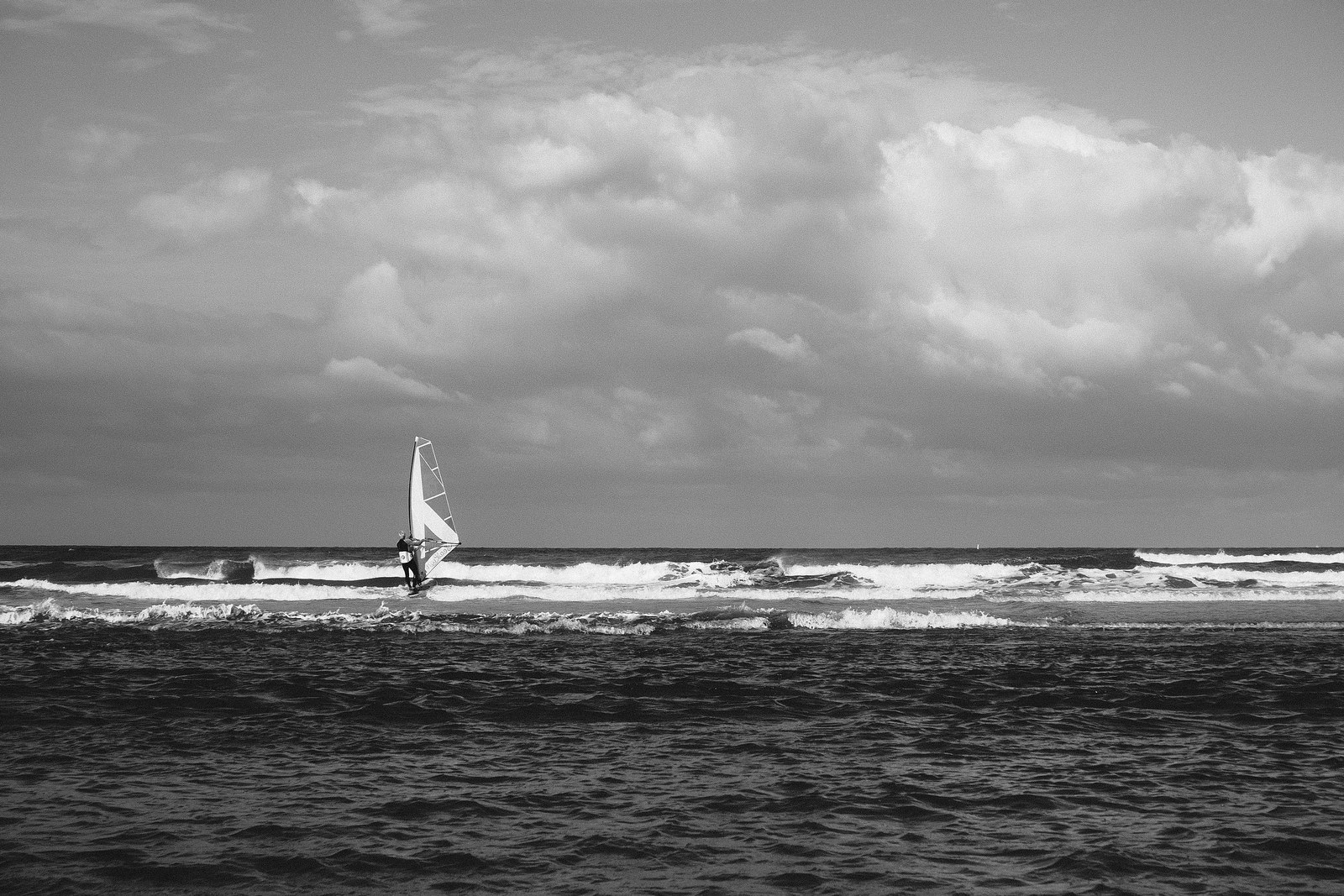 a windsurfer on the north sea in dramatic monochrome